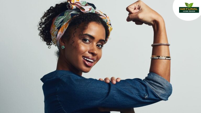 A woman displays a powerful stance with her fist raised high, adorned with a headband on her arm, embodying empowerment.