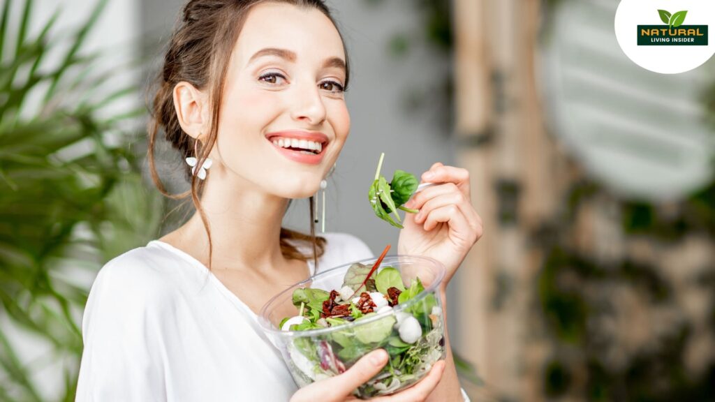 A smiling woman presents a vibrant salad, emphasizing freshness and enjoyment in healthy eating.