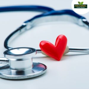A stethoscope rests beside a heart-shaped object, symbolizing the connection between healthcare and compassion.