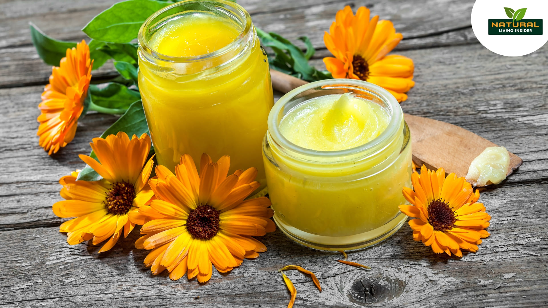 A bottle of calendula oil surrounded by fresh calendula flowers, highlighting its skin care benefits and health properties.