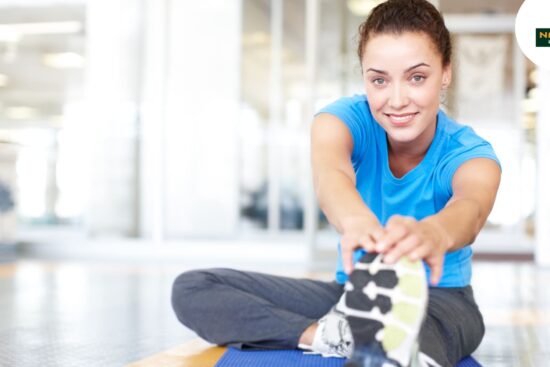 A woman stretches on a mat, embodying holistic health and well-being.