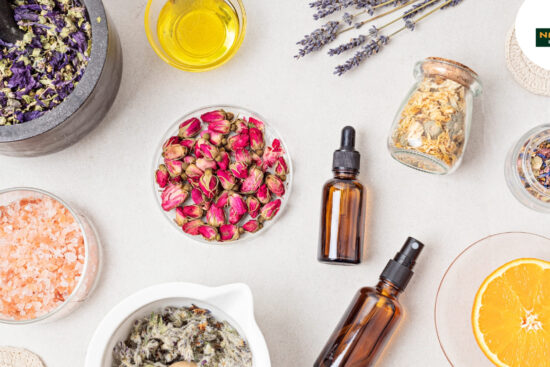 A table displays an assortment of herbs and oils, ideal for crafting organic skincare products at home.