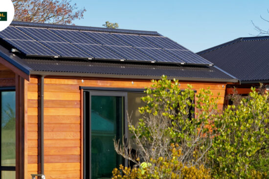 A small wooden house featuring solar panels on the roof, symbolizing self-sufficiency and off-grid living.