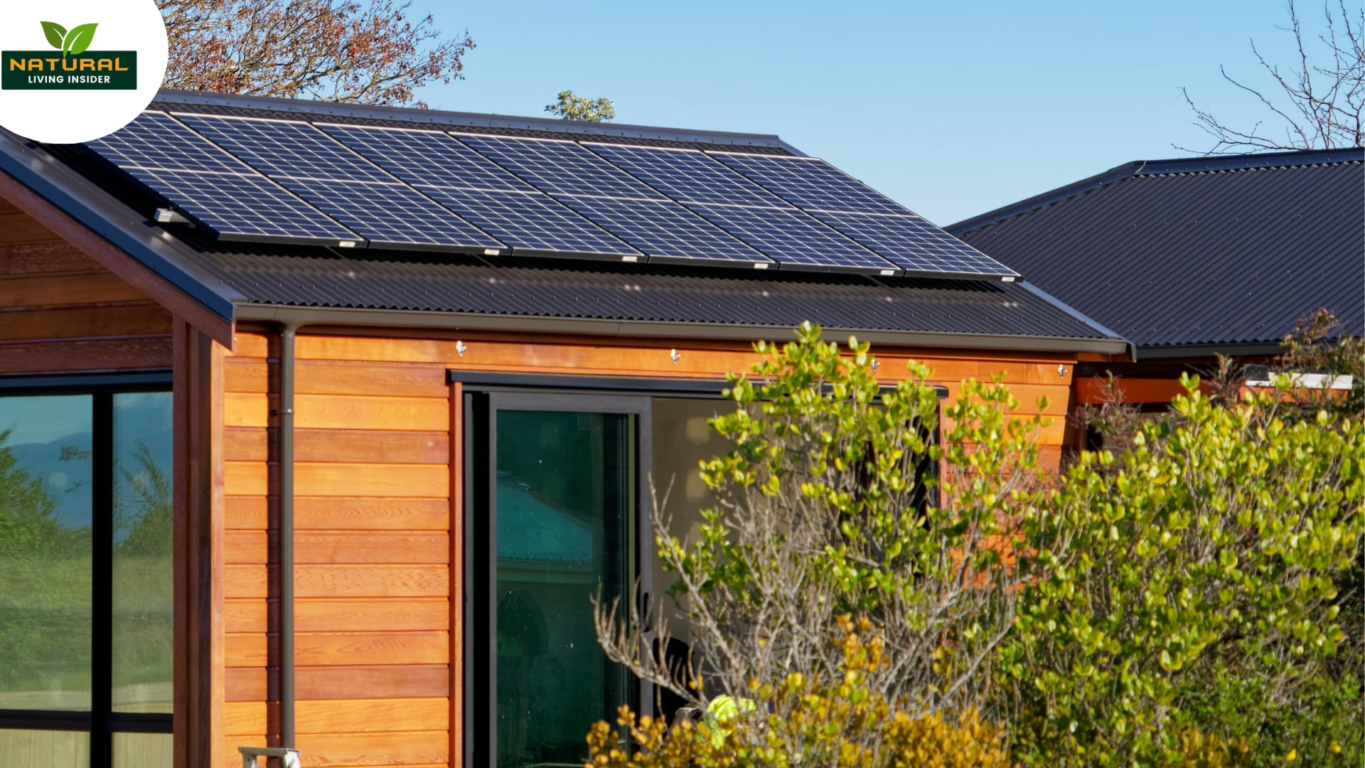 A small wooden house featuring solar panels on the roof, symbolizing self-sufficiency and off-grid living.