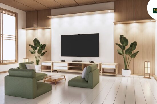 A minimalist living room featuring a large TV and stylish green chairs.