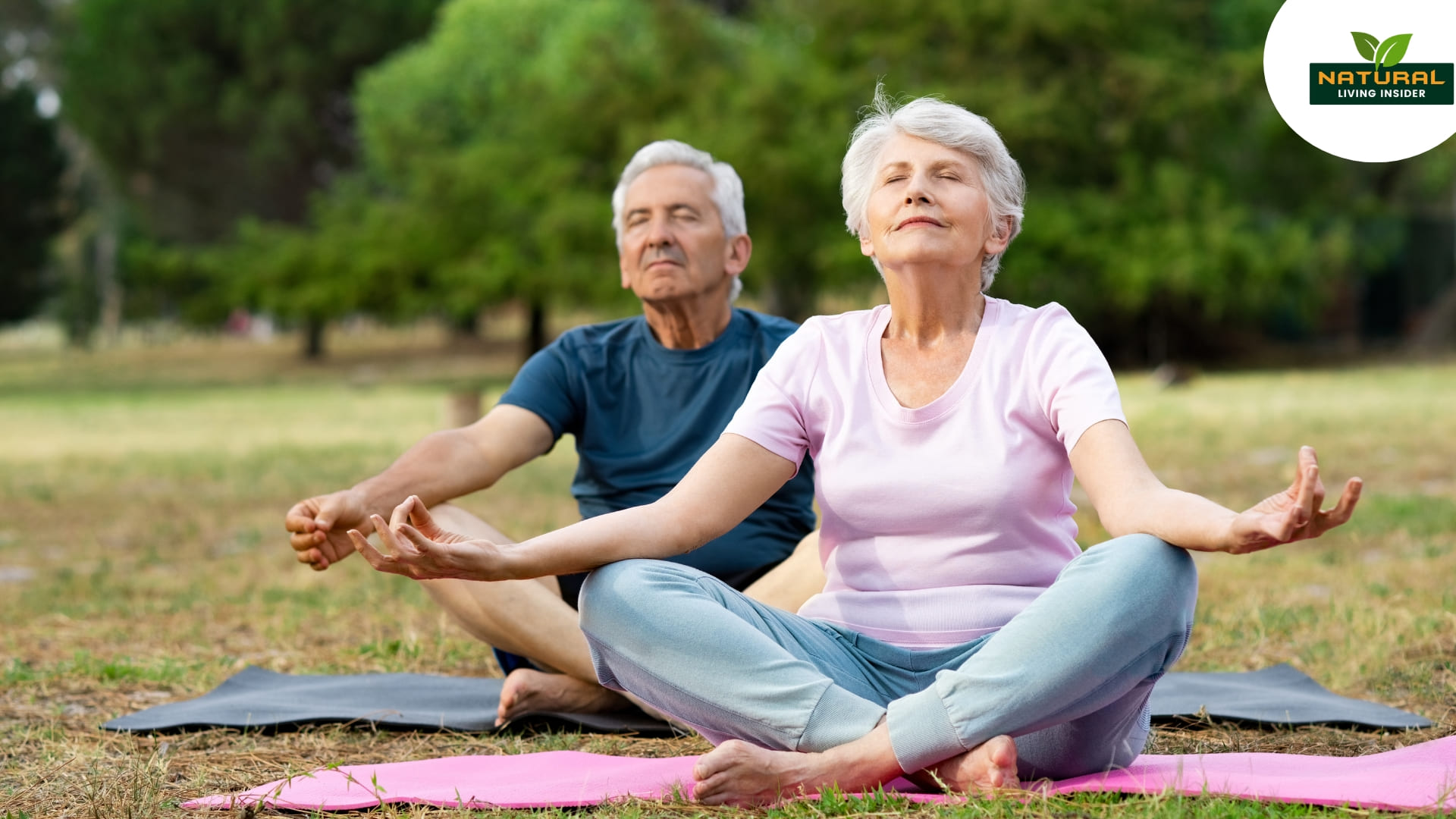 A men and old women doing peacefully yoga in the garden.