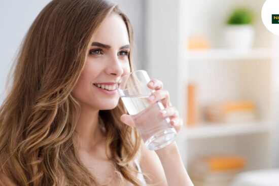 A lady drink warm water at early in the morning