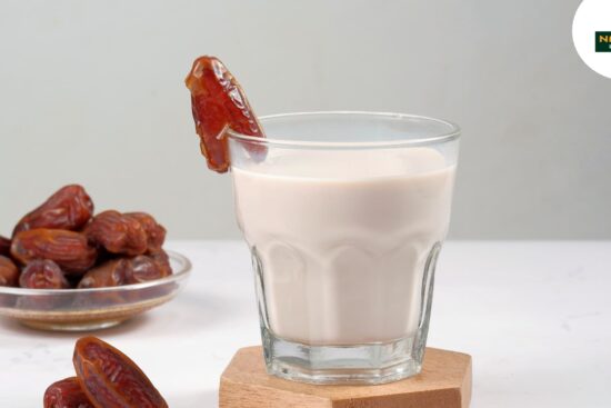 A glass of milk with a few dates and showcasing a wholesome snack option for boost energy.