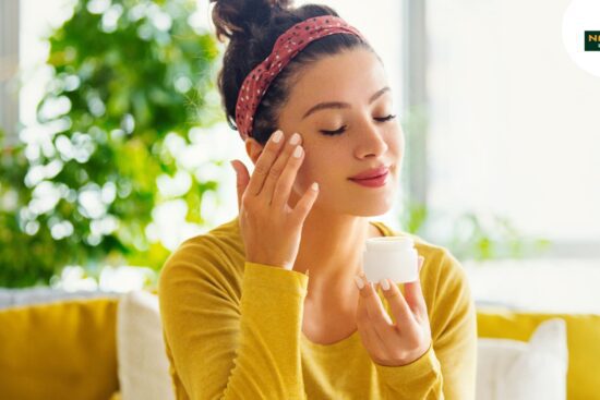 A woman cleanses her face with cream, highlighting Ayurvedic skin care methods for all skin types.