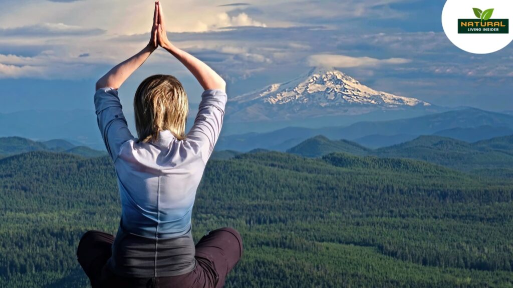 A woman meditates for inner peace with peacefully before a majestic mountain.