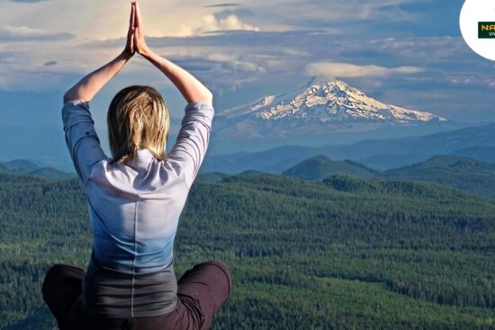 A woman meditates for inner peace with peacefully before a majestic mountain.